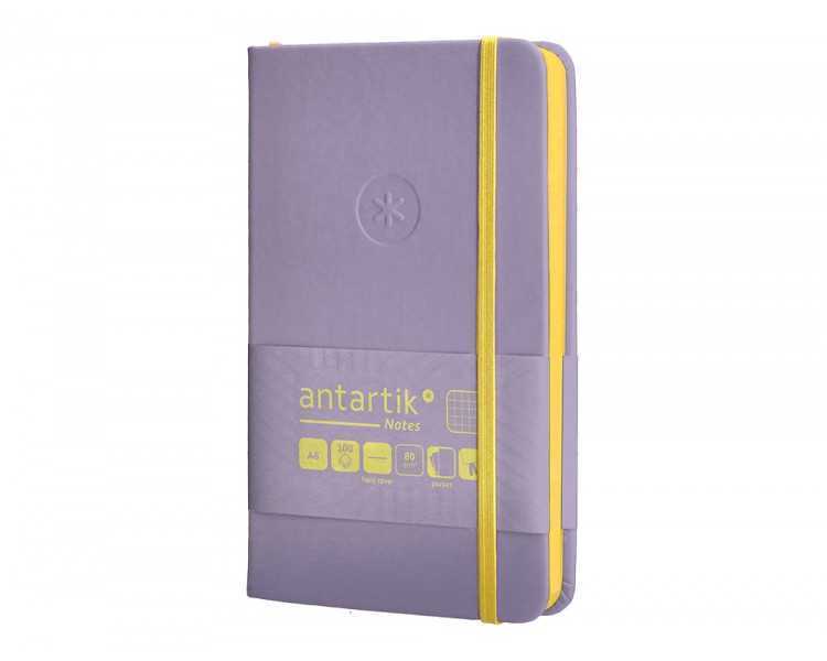 Cuaderno con gomilla antartik notes tapa dura a6 hojas cuadricula morado y amarillo 100 hojas 80 gr fsc